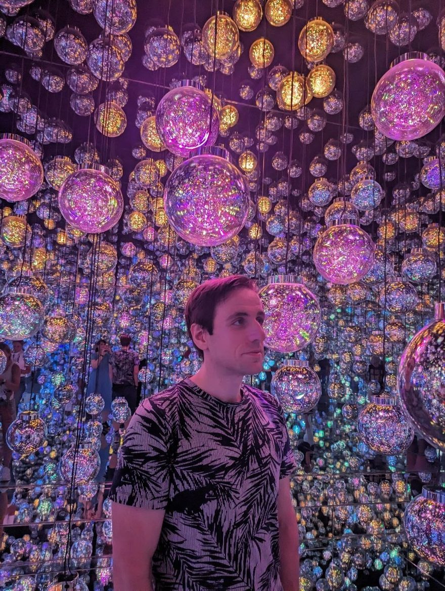 Sven Eliasson, standing in a room full of mirrored light spheres